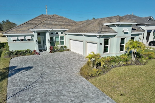 view of front of house with a garage and a front lawn