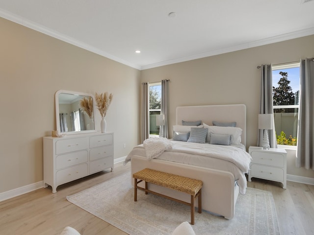 bedroom featuring multiple windows, crown molding, and light hardwood / wood-style floors