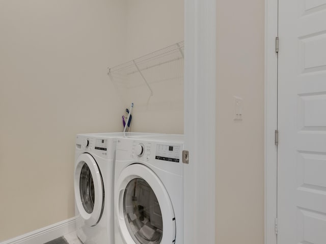 laundry room with tile patterned floors and washing machine and dryer