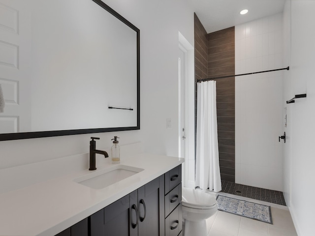 bathroom featuring curtained shower, tile patterned flooring, vanity, and toilet