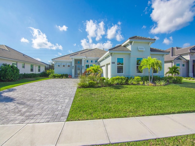 view of front of property with a front yard and a garage