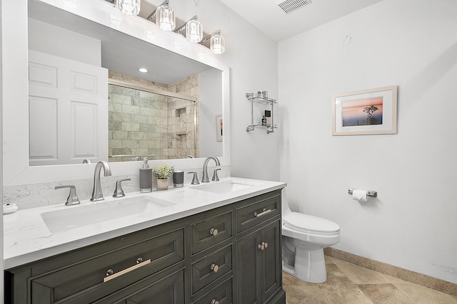 bathroom featuring tile patterned flooring, an enclosed shower, vanity, and toilet