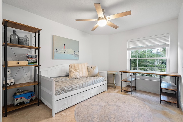 interior space with ceiling fan and a textured ceiling