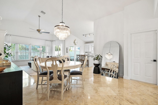 dining room featuring ceiling fan with notable chandelier and high vaulted ceiling