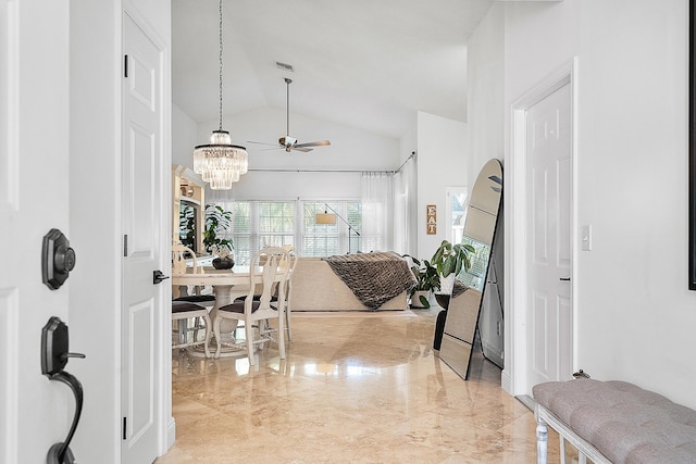 entryway featuring ceiling fan with notable chandelier and vaulted ceiling