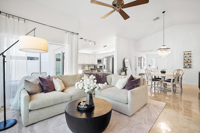 living room with lofted ceiling and ceiling fan with notable chandelier