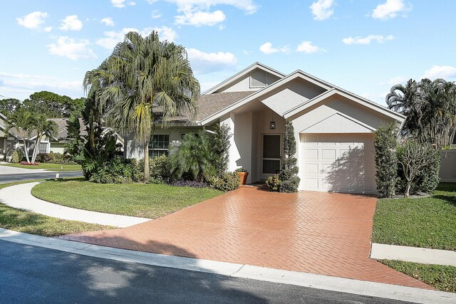 view of front of house with a front lawn and a garage