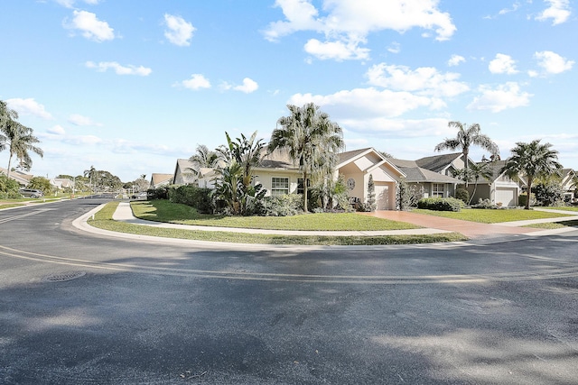 view of front of home featuring a front yard and a garage