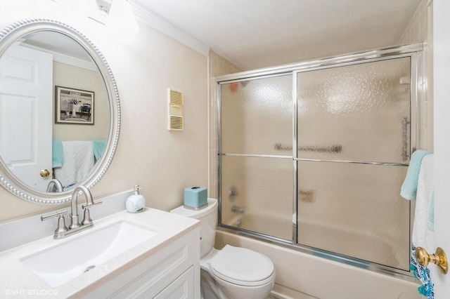 full bathroom featuring vanity, combined bath / shower with glass door, ornamental molding, and toilet