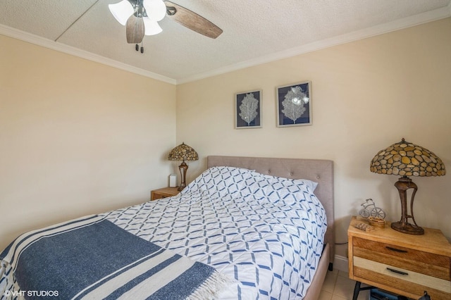 tiled bedroom featuring crown molding, ceiling fan, and a textured ceiling