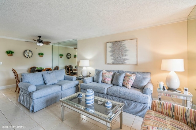 living room with crown molding, ceiling fan, a textured ceiling, and light tile patterned floors