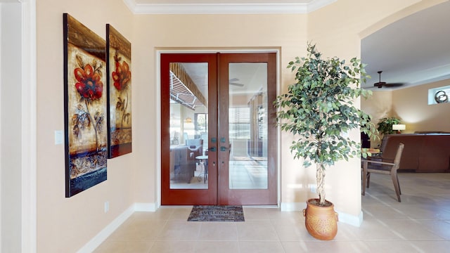 entryway with light tile patterned floors, crown molding, and french doors