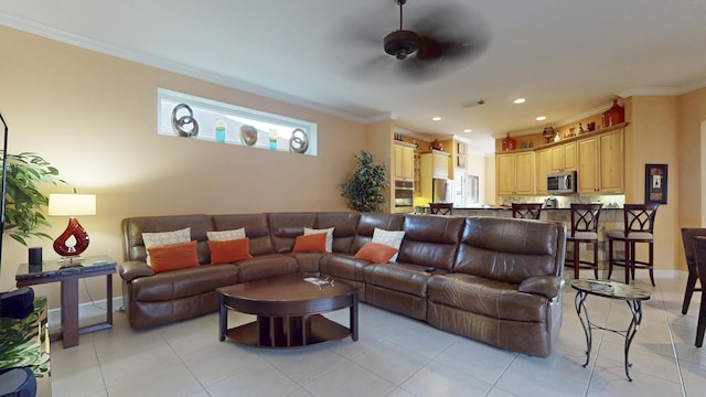 tiled living room featuring ceiling fan and ornamental molding