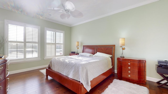 bedroom featuring ceiling fan, dark hardwood / wood-style floors, and crown molding