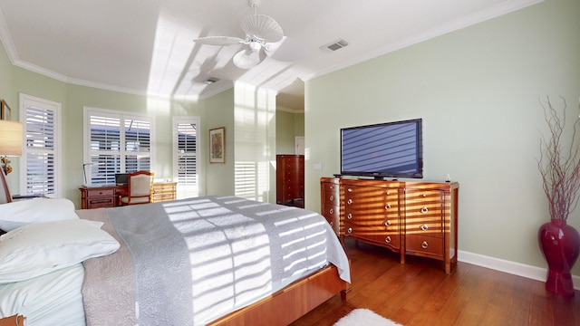 bedroom with dark hardwood / wood-style floors, ceiling fan, and ornamental molding