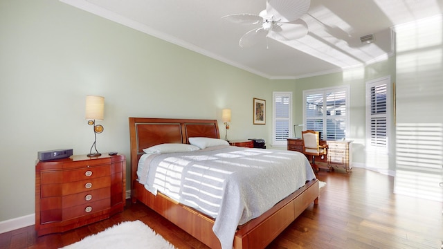 bedroom with ceiling fan, wood-type flooring, and ornamental molding