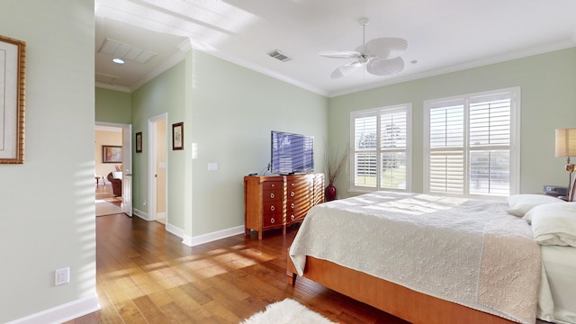 bedroom featuring hardwood / wood-style flooring, ceiling fan, and crown molding