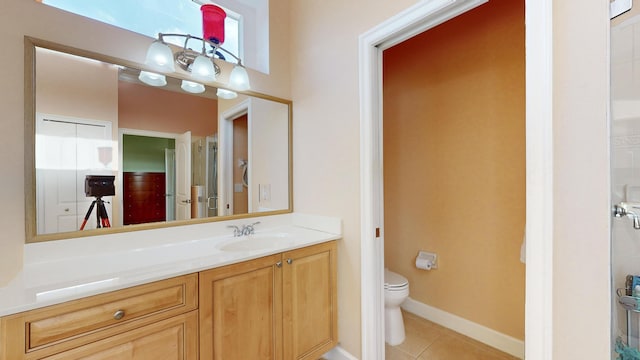 bathroom featuring tile patterned floors, vanity, and toilet