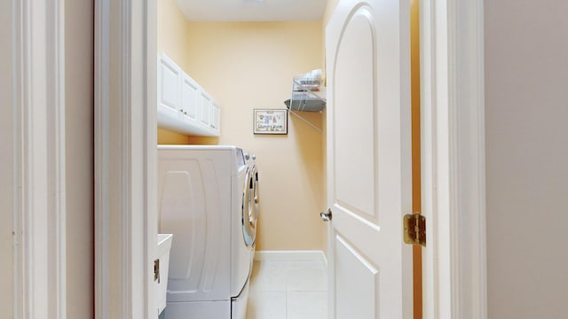 laundry room with separate washer and dryer and light tile patterned floors