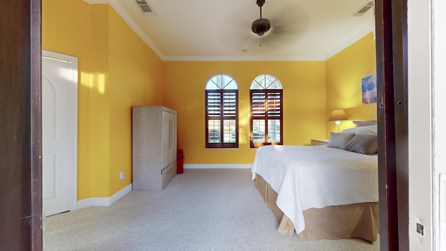 carpeted bedroom featuring ceiling fan and ornamental molding