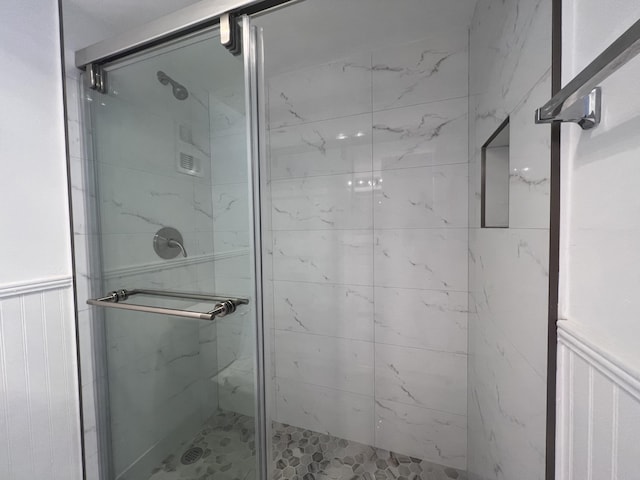 bathroom with a shower with door