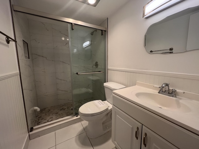 bathroom with tile patterned floors, vanity, toilet, and an enclosed shower