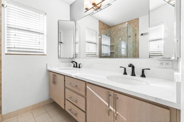 bathroom with tile patterned flooring, vanity, toilet, and an enclosed shower