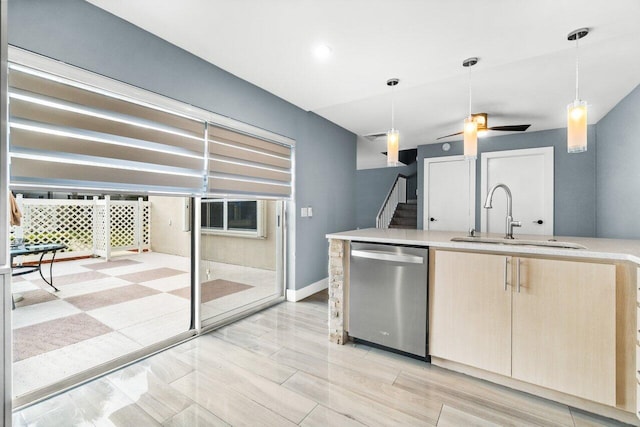 kitchen with sink, stainless steel dishwasher, ceiling fan, light brown cabinetry, and decorative light fixtures