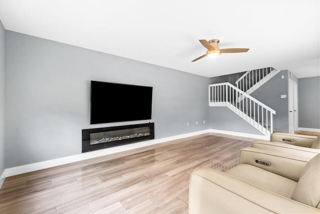 unfurnished living room with hardwood / wood-style floors and ceiling fan