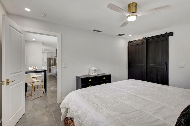 bedroom featuring a barn door and ceiling fan