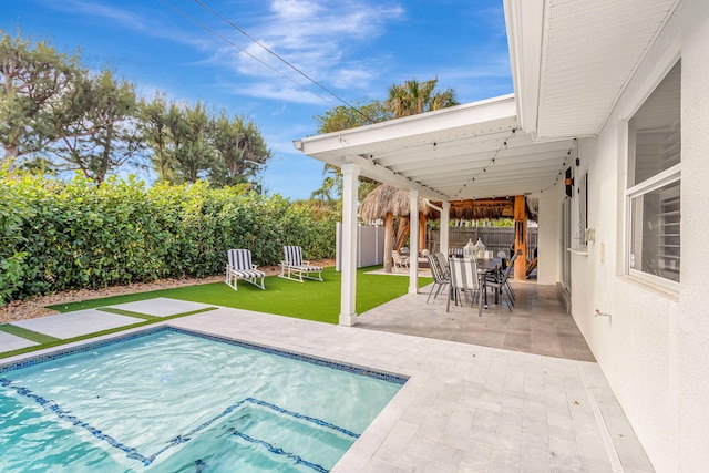 view of pool with a lawn and a patio