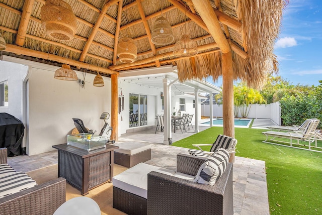 view of patio featuring a gazebo, an outdoor living space, a grill, and a fenced in pool