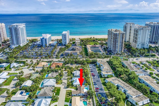 drone / aerial view featuring a water view and a view of the beach