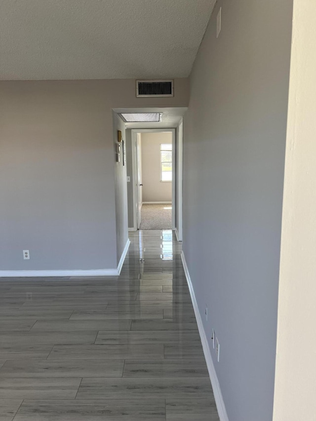 corridor with a textured ceiling