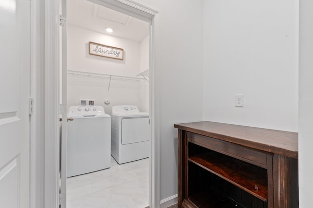 washroom with washing machine and dryer and light tile patterned flooring