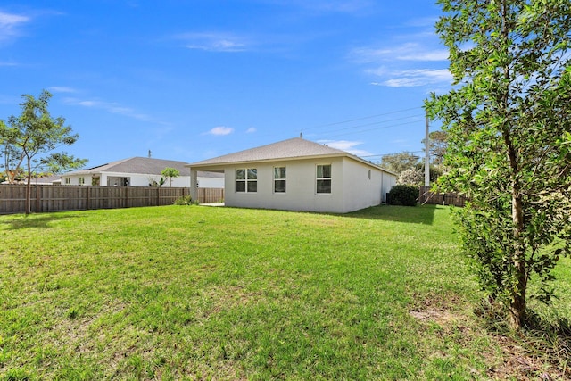 rear view of house featuring a lawn