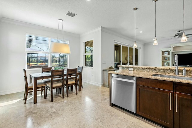 kitchen with a wealth of natural light, sink, stainless steel dishwasher, crown molding, and decorative light fixtures