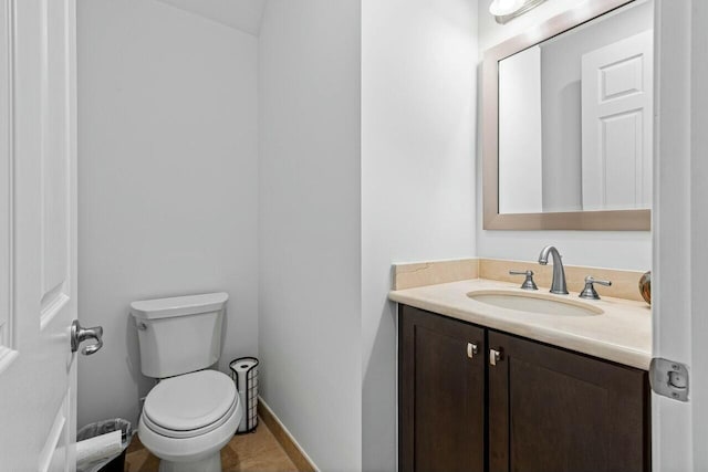 bathroom with tile patterned floors, vanity, and toilet