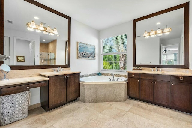 bathroom with vanity and shower with separate bathtub