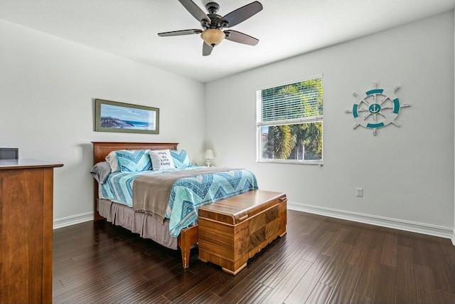 bedroom with dark hardwood / wood-style flooring and ceiling fan