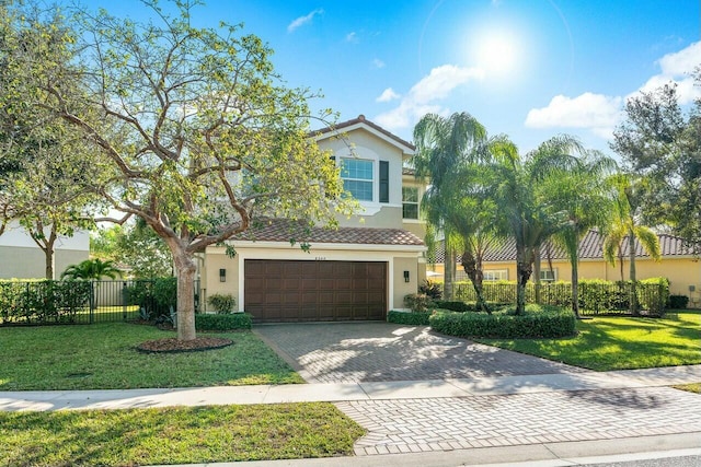 view of front of house with a garage and a front lawn