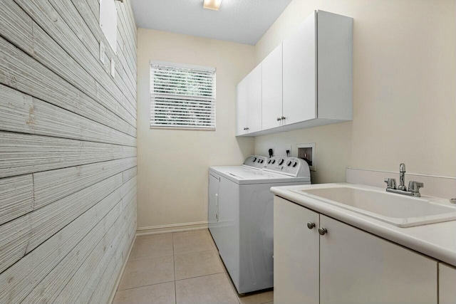 washroom with washer and clothes dryer, cabinets, light tile patterned floors, and sink