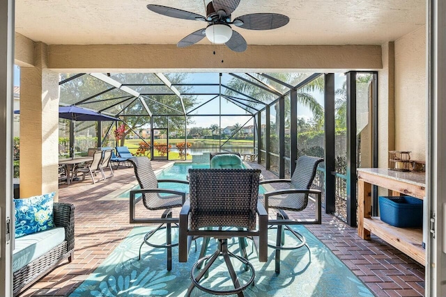 view of patio / terrace featuring a lanai and ceiling fan