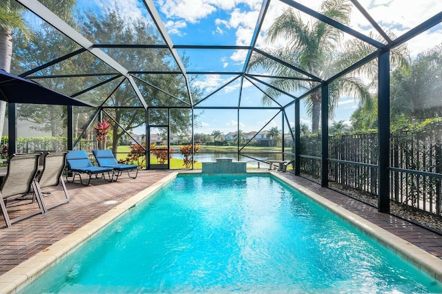 view of swimming pool with a patio area and glass enclosure