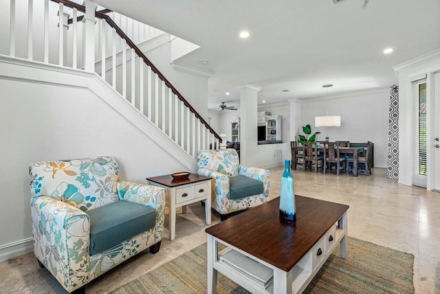 living room with ceiling fan, ornamental molding, and decorative columns