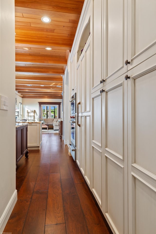 hall with recessed lighting, dark wood-style floors, and wooden ceiling