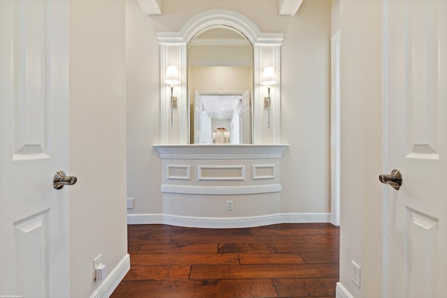 hallway with hardwood / wood-style floors and baseboards