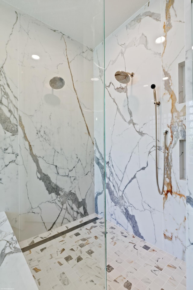 bathroom with a marble finish shower