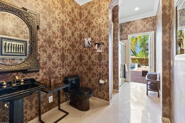 full bathroom with tile patterned floors, toilet, ornamental molding, wallpapered walls, and baseboards