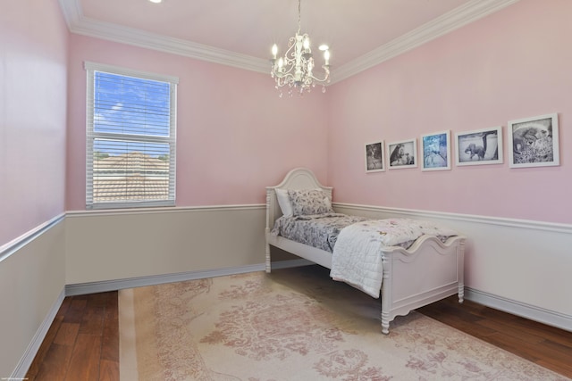 bedroom featuring an inviting chandelier, crown molding, wood finished floors, and baseboards